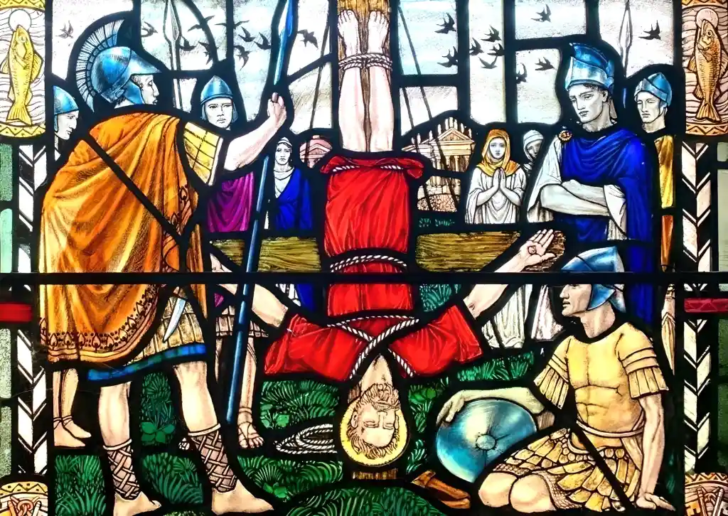 A stained glass window of the martyrdom of St Peter, by Sister Margaret Rope.